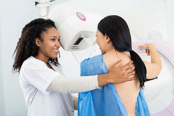 woman getting a mammogram by female doctor