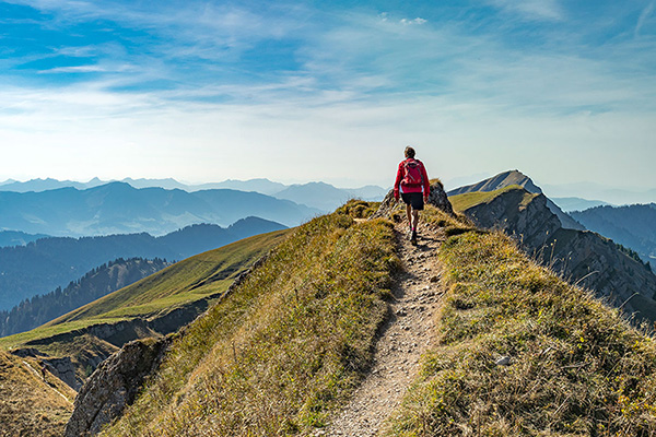 person hiking up a mountain