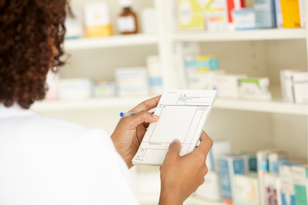 Doctor handling prescription pill pack to outstretched hand