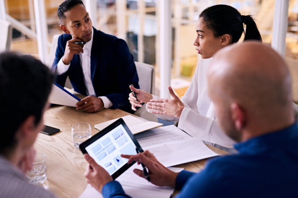Diverse business people in a meeting discussing data