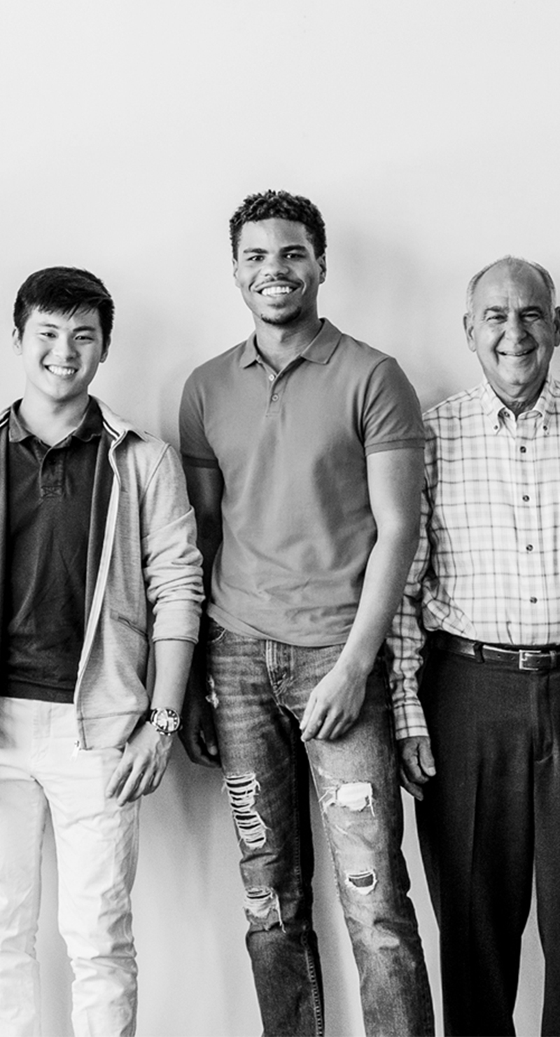 Diverse men standing and smiling at the camera