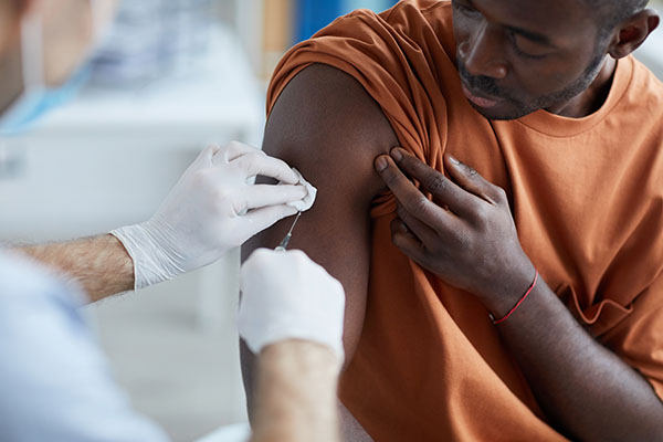 Black man receiving a vaccine