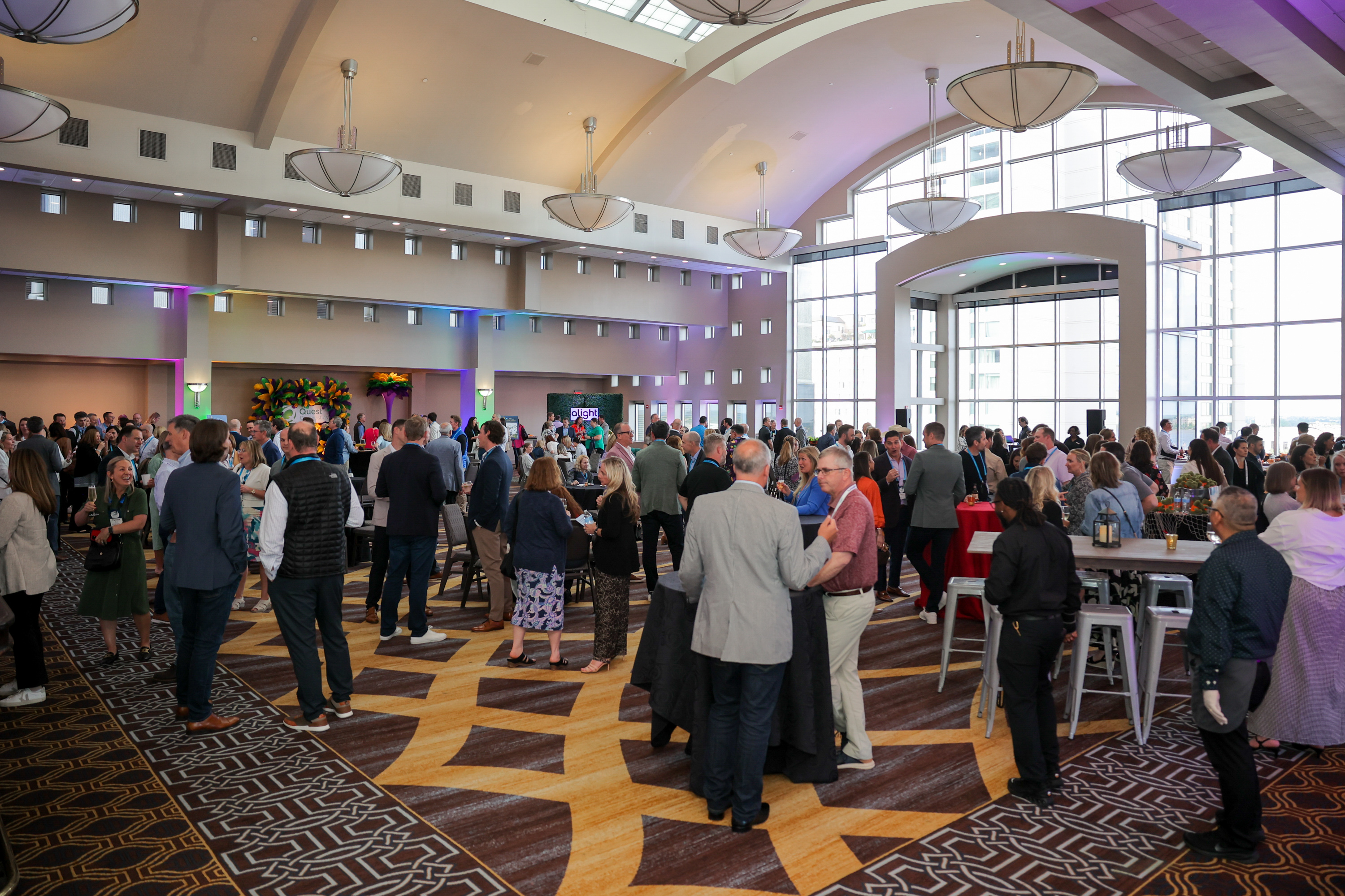 Conference attendees mingling at a reception area