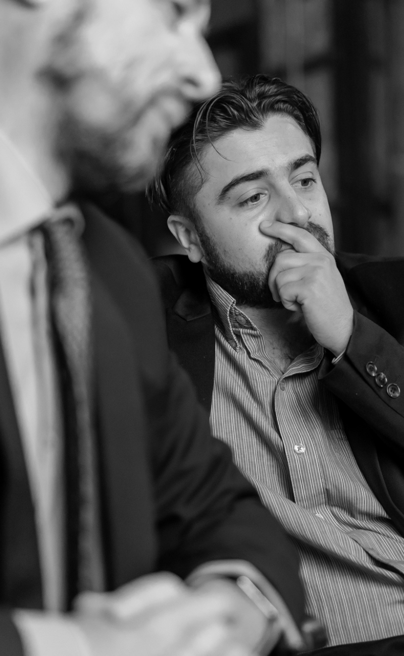 Man holding chin and mouth with hand